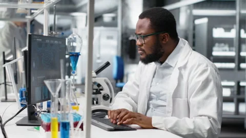 Laboratory worker squinting eyes at computer, struggling to understand DNA data Stock Footage 320727654