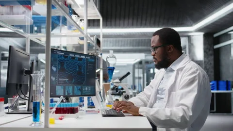 Laboratory worker squinting eyes at computer, struggling to understand DNA data Stock Footage 320736012