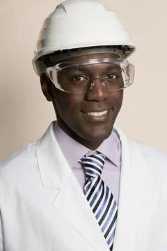 Laboratory worker wearing hard hat, protective goggles and lab coat Stock Photos