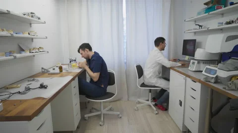 Laboratory Workers are manufacturing jaw replacements at a dentistry clinic Stock Footage