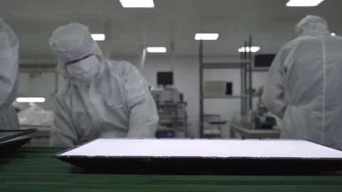 Laboratory workers assemble and test TVs on a conveyor belt in the laboratory Stock Footage 233034867