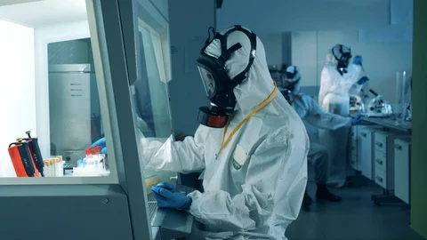 Laboratory workers develop a covid-19 vaccine while working in laboratory with Stock Footage 129915041