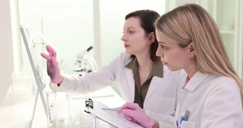 Laboratory workers input research results on computer Stock Footage 279723217