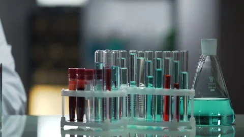 Laboratory working surface occupied by test tubes and flasks, research process Stock Footage 73954607