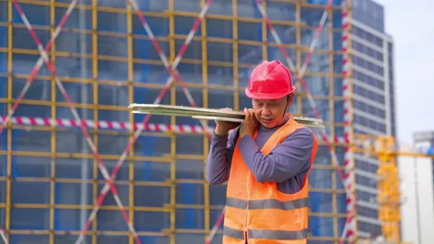 Laborer construction man worker wearing red hard hat, orange safety vest Stock Footage 345860031