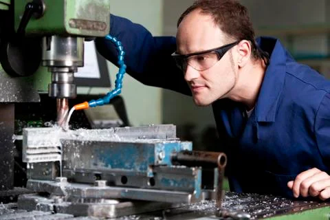 Laborer at milling machine. Stock Photos
