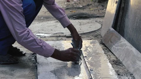 Laborer using stone cutting machine at outdoor construction area Stock Footage 319074238