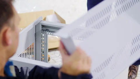 Laborers assemble modern switch box in case at construction Stock Footage 125644170
