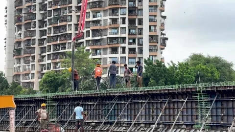 Laborers working pour cement for a new highway flyover construction Stock Footage 337161215