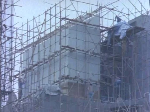Labors work at the site of an under-construction building Stock Footage 79877076
