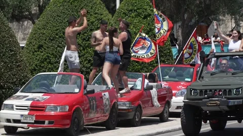 Labour supporters parade through Valletta with Maltese flags and vehicles Stock Footage 336490804