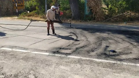 A labour worker is busy in making the road. Stock Footage 143328181
