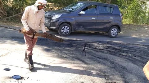 A labour worker is busy in making the road. Stock Footage 143328238