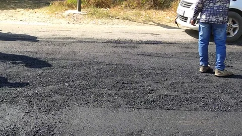A labour worker is busy in making the road. Stock-Footage 143328281
