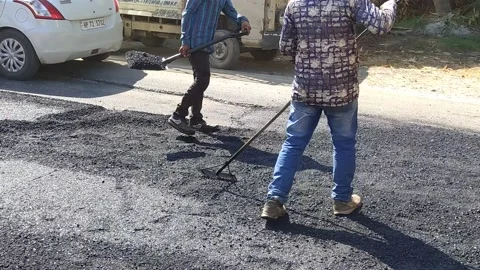 A labour worker is busy in making the road. Stock Footage 143328289