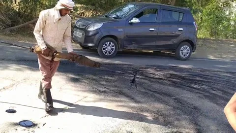 A labour worker is busy in making the road. Stock Footage 143328321