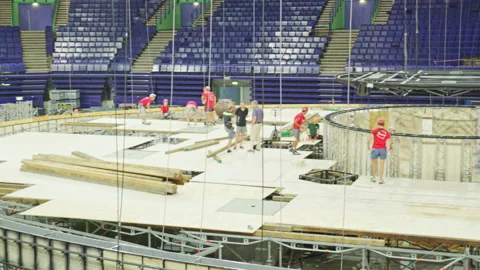 Labourers assembly swimming pool frame at sports stadium Stock Footage 237004616