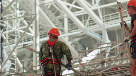 Labourers transmit tubes for pipeline installation at pool Stock Footage 237006029