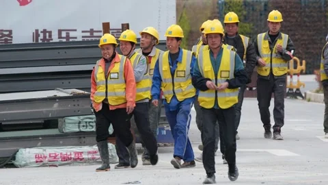 Labourers walking towards a construction site in Shanghai Stock Footage 270194985