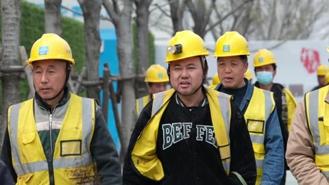Labourers walking towards a construction site in Shanghai Stock Footage 270194986