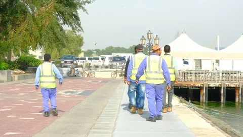 Labours walking at Doha corniche walkway Video stock 125337911