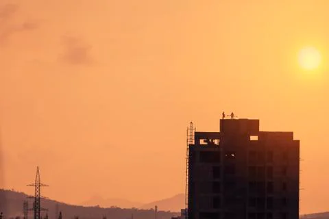 Labours working on construction site at sunset Stock Photos