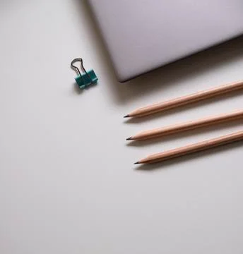 Labtop and clip binder on the white table in office Stock Photos