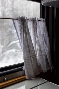 Lace curtains on the window in the train carriage Stock Photos