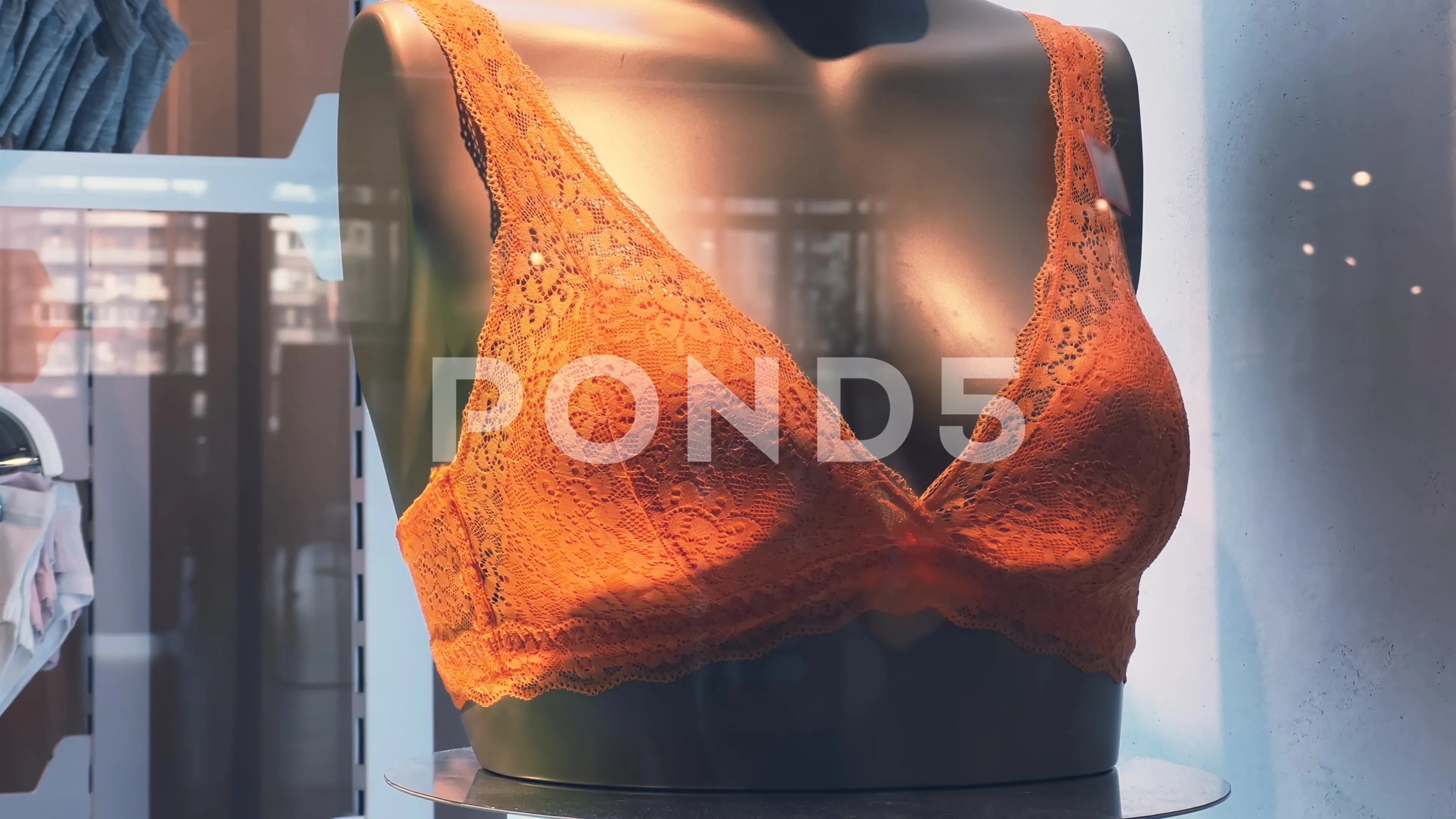 Orange female mannequins in underwear. Lingerie store, lace bra