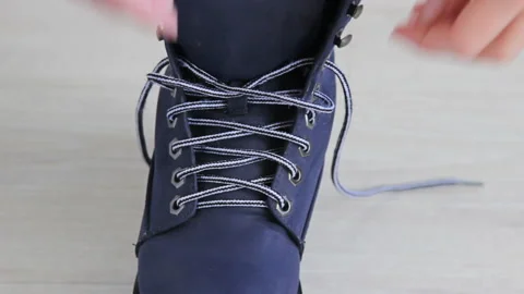 Lacing Up the Boots . Close up of shoes. Stock Footage 130533274