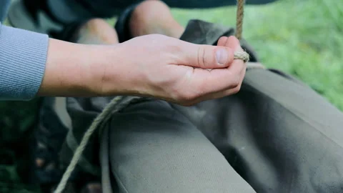 Lacing Up Boots in the Field, Close-up of hands lacing up boots with a durable Stock Footage 264275203