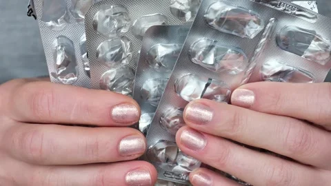 Lack of drugs in the pharmacy.hands are sorting through  packaging from pills. Stock Footage 241640425
