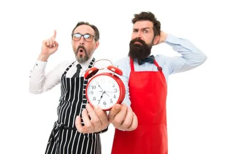Lack of time. Check what time is it. It is lunch time. Men cooks with alarm 库存照片