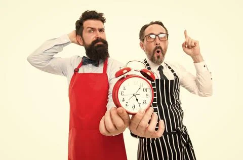 Lack of time. Check what time is it. It is lunch time. Men cooks with alarm Foto stock