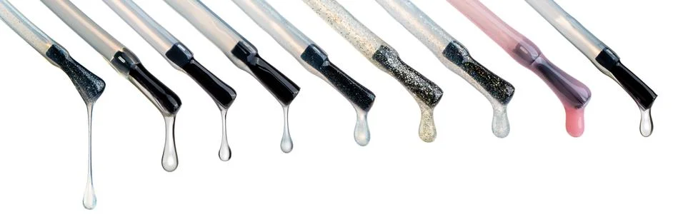 Lacquer drops at the tip of the brush. Different colored vicious liquid drops Stock Photos