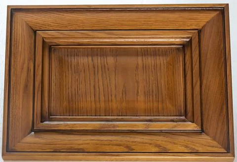 Lacquered textured brown rectangular kitchen facade close-up. wood textured d Stock Photos