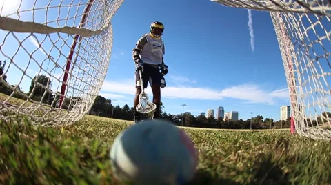 Lacrosse player practicing taking shots at a goal , slow motion. Stock Footage 68536881