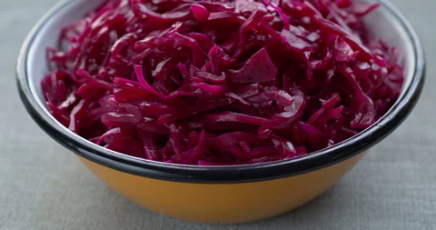 Lacto-fermented red cabbage salad in metal enamel bowl. Table spin. Stock Footage 278235008