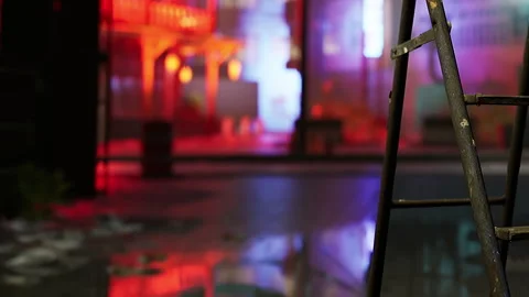 Ladder in an empty space with colorful lights and reflections on the floor Stock Footage 342038774
