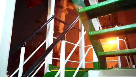 Ladder glistens under dim light as raindrops slide down Stock Footage 320435014