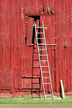 Ladder on a red barn Stock Photos