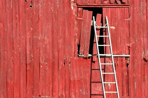Ladder on a red barn Stock Photos