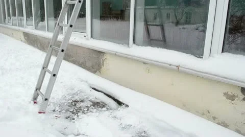 Ladder stand conservatory greenhouse glass wall snow fall ground Stock Footage
