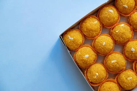 Laddu sweets kept in the box packing with pale blue background Stock Photos