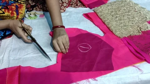 A Ladies tailor cutting the clothes with scissors and making a modern dress Stock Footage 162149130