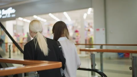 Ladies Walking Toward Escalator in Modern Mall Stock Footage 320134522