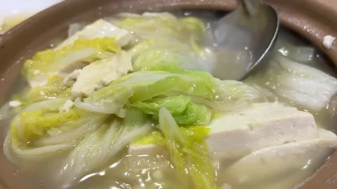 Ladle Serving Tofu Cabbage Hot Pot into Bowl Stock Footage 332259819
