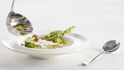 Ladle Serving Vegetarian Soup with mushrooms and asparagus Into A Bowl Video stock 104001653