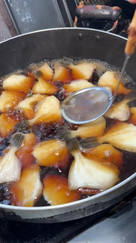 Ladling Soy Broth Over Simmering Filefish, Japanese Simmered Fish, Izakaya Japan Stock Footage 344911868