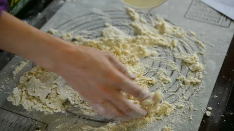 Lady adding water into flour and kneading dough at home Stock Footage 126902264